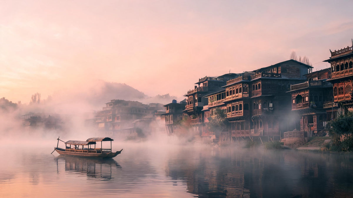 Old wooden houses of Srinagar along the Jhelum river at dawn, with a boat on the misty water