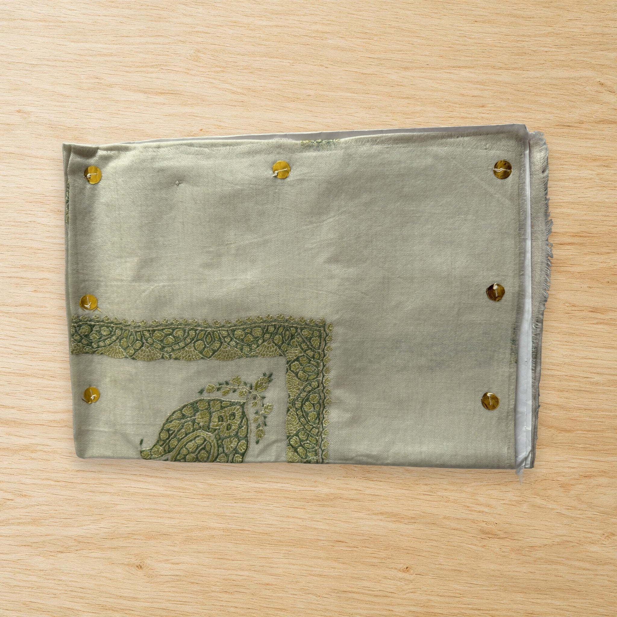 Akhdar Kashmiri pashmina ghutra laid flat on a wooden table, true to life colour