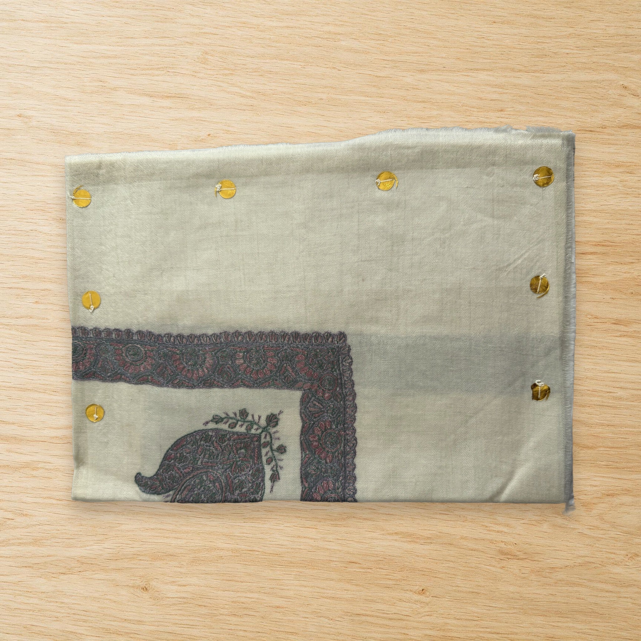 Habr Kashmiri pashmina ghutra laid flat on a wooden table, true to life colour