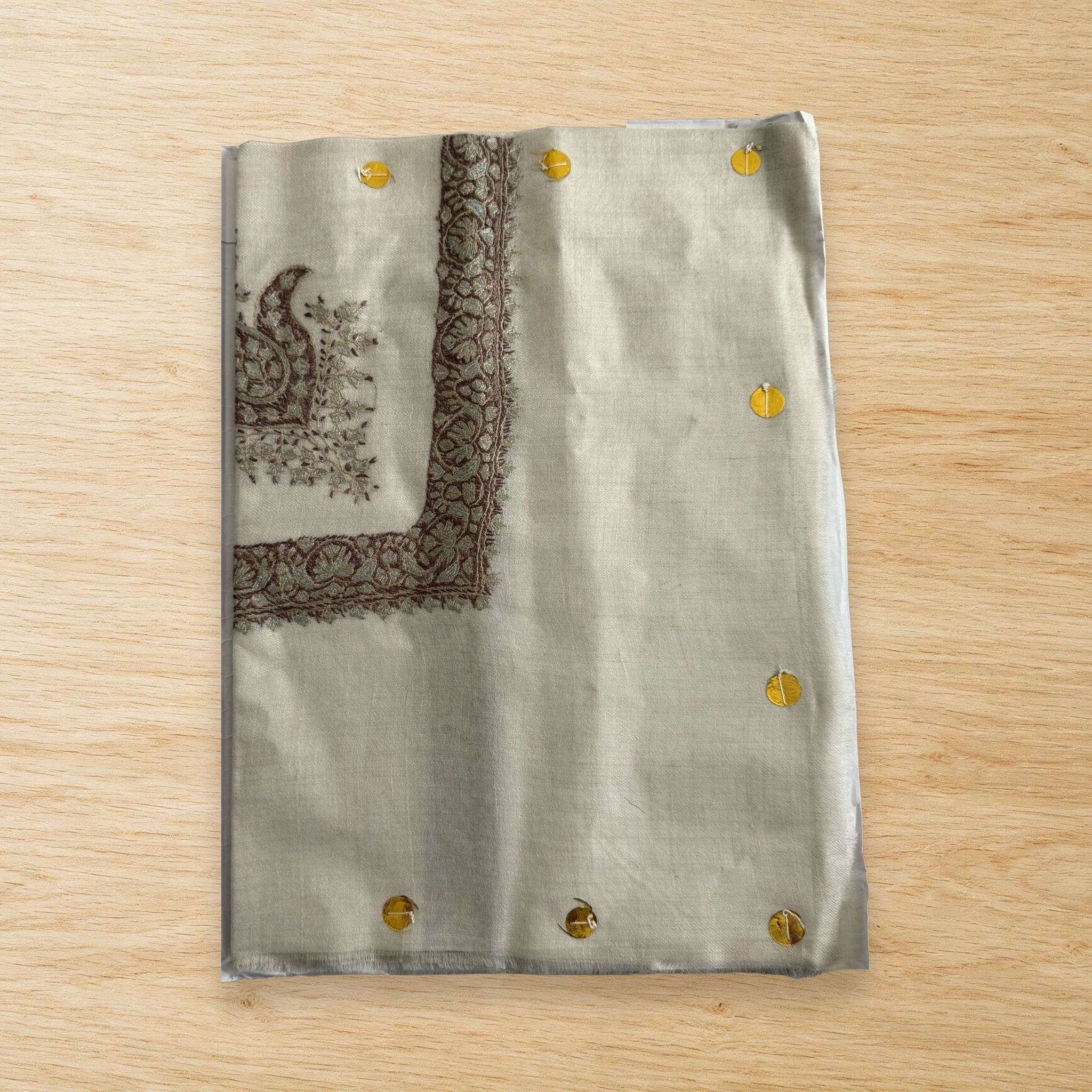 Reem Kashmiri pashmina ghutra laid flat on a wooden table, true to life colour