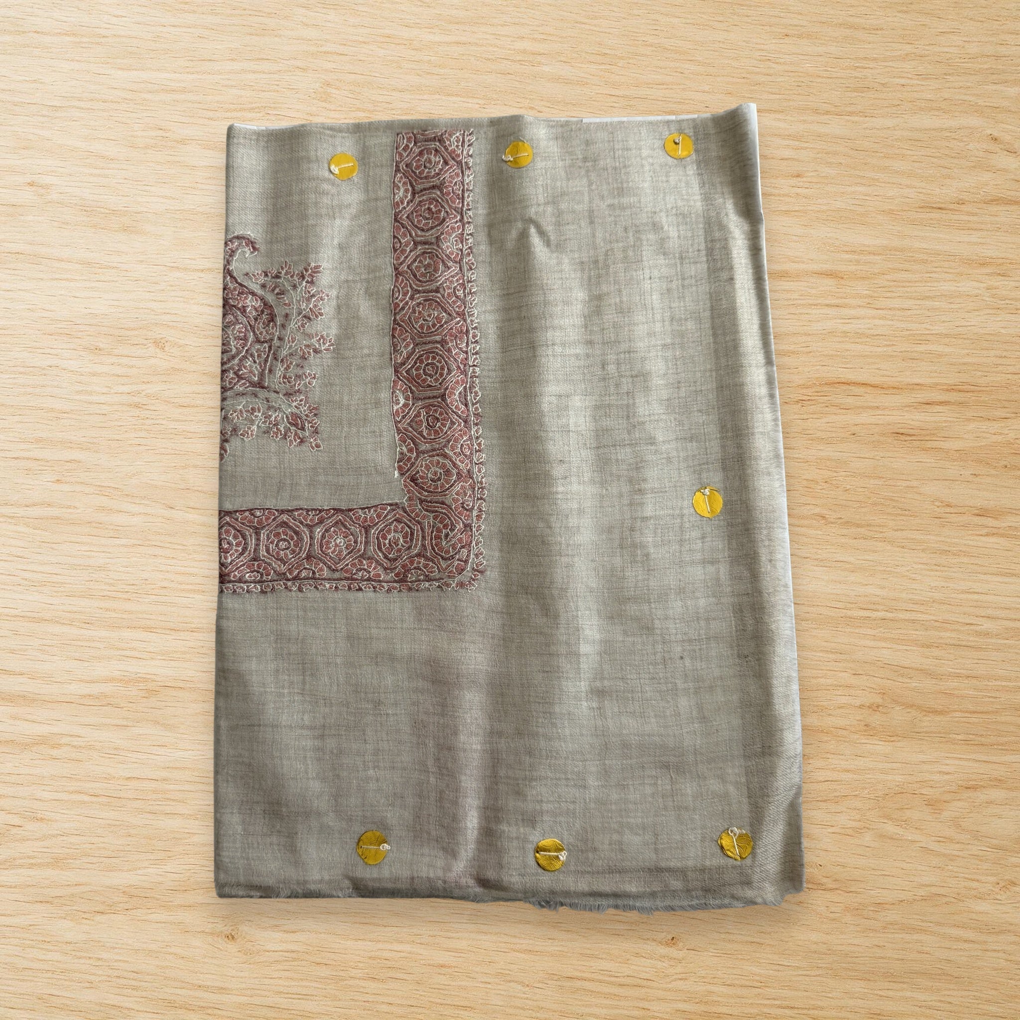 Julanar Kashmiri pashmina ghutra laid flat on a wooden table, true to life colour