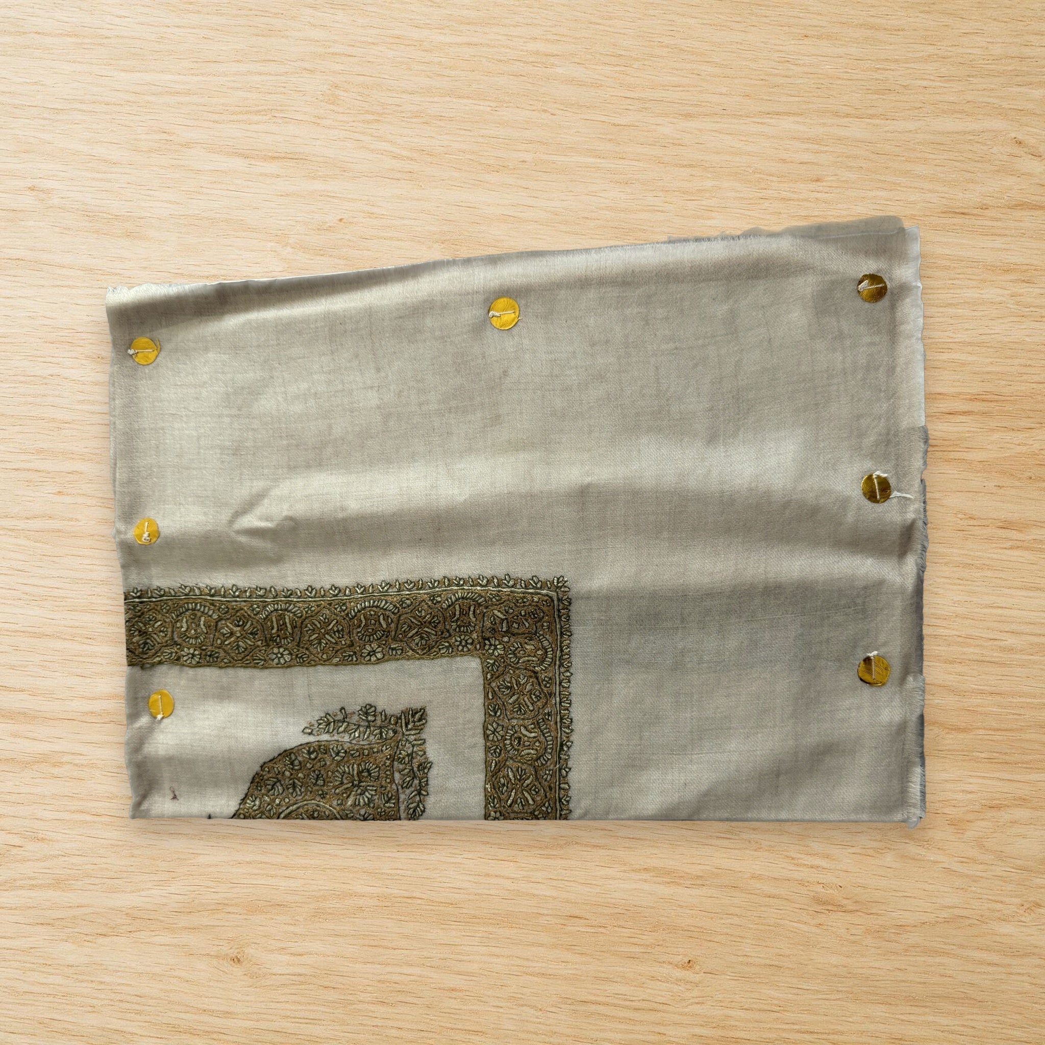 Anbar Kashmiri pashmina ghutra laid flat on a wooden table, true to life colour