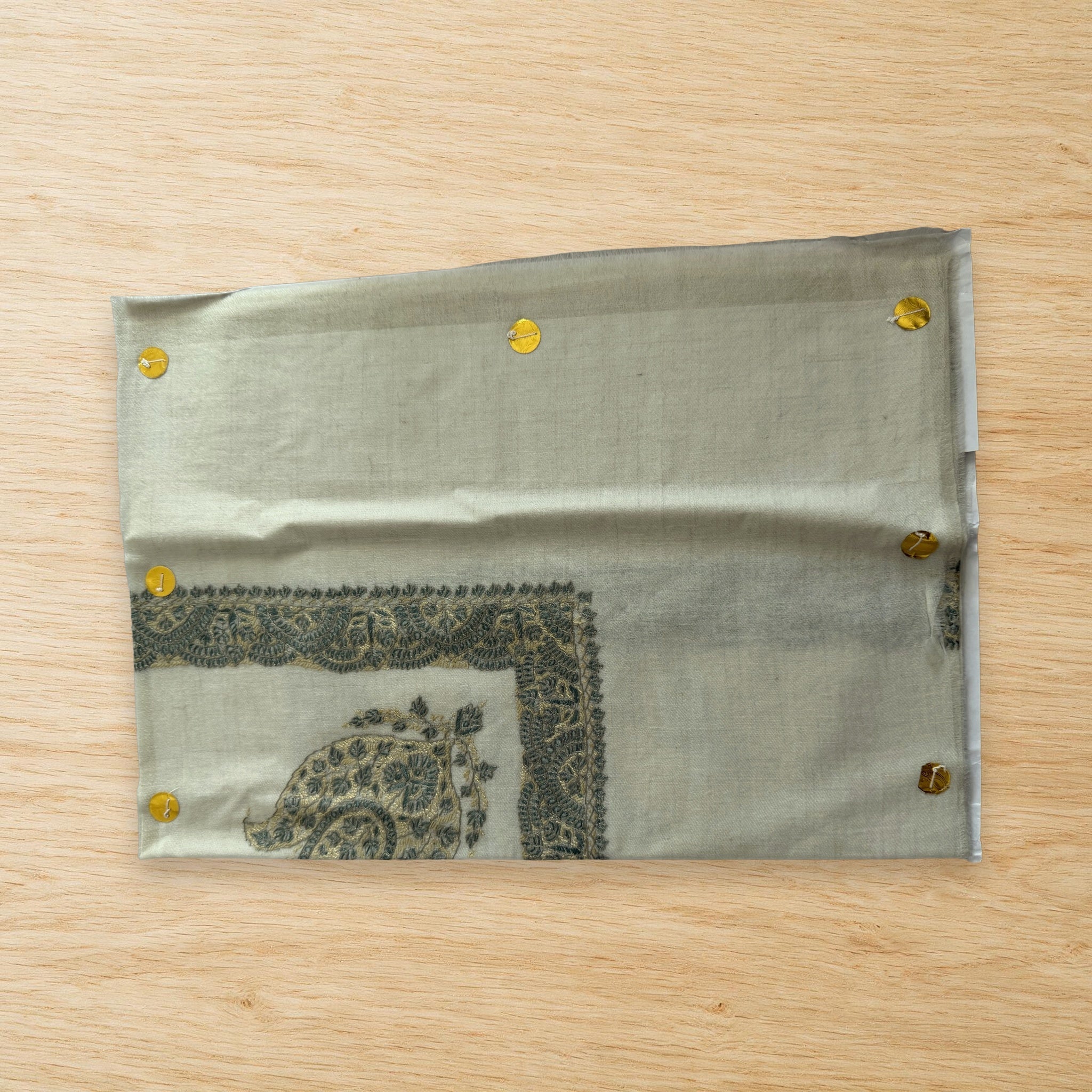 Firouz Kashmiri pashmina ghutra laid flat on a wooden table, true to life colour