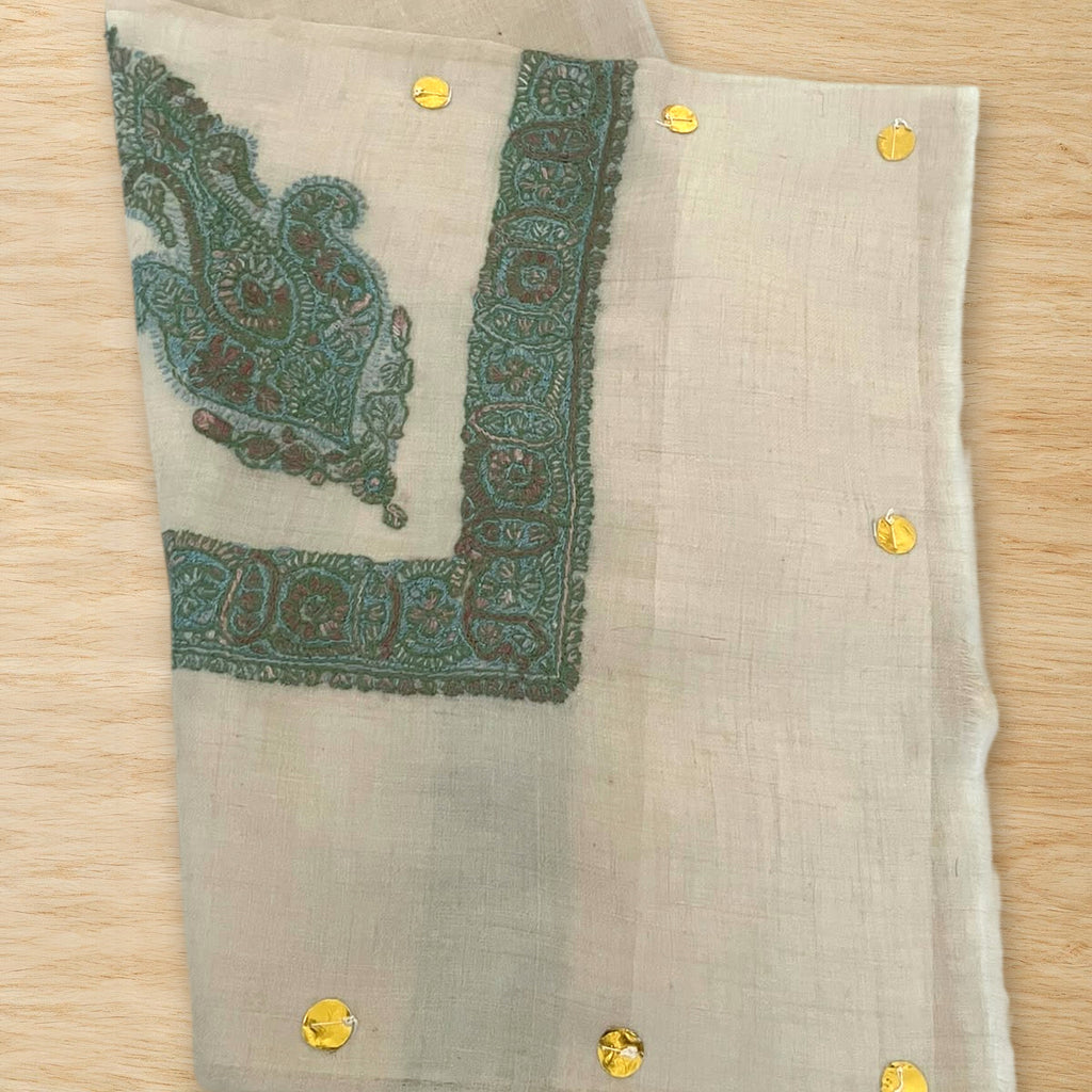 Zumurrud Kashmiri pashmina ghutra folded on a wooden table, true to life colour