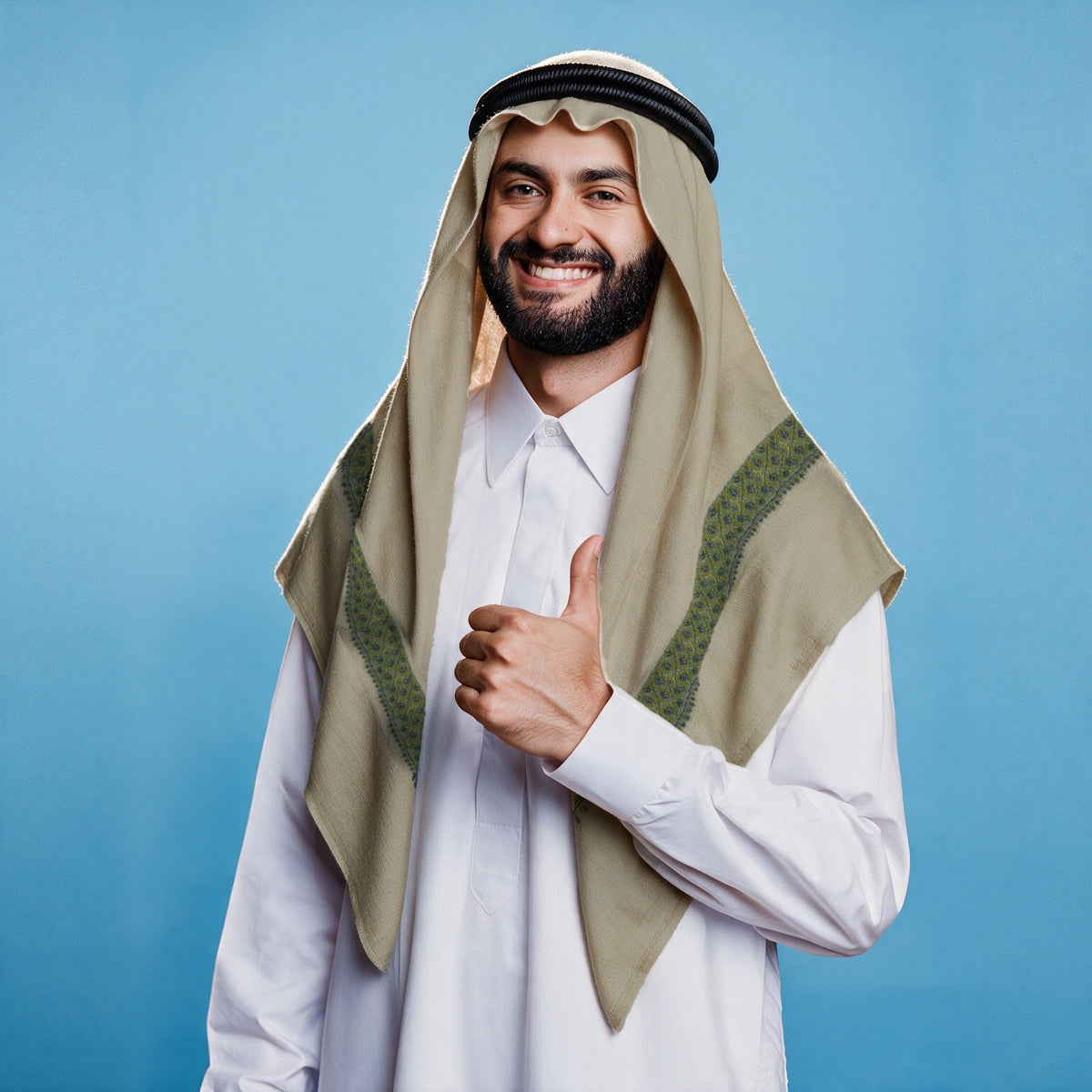 Man wearing the Murj Kashmiri pashmina ghutra with a black agal and white thobe, moss green sozni border on each front end