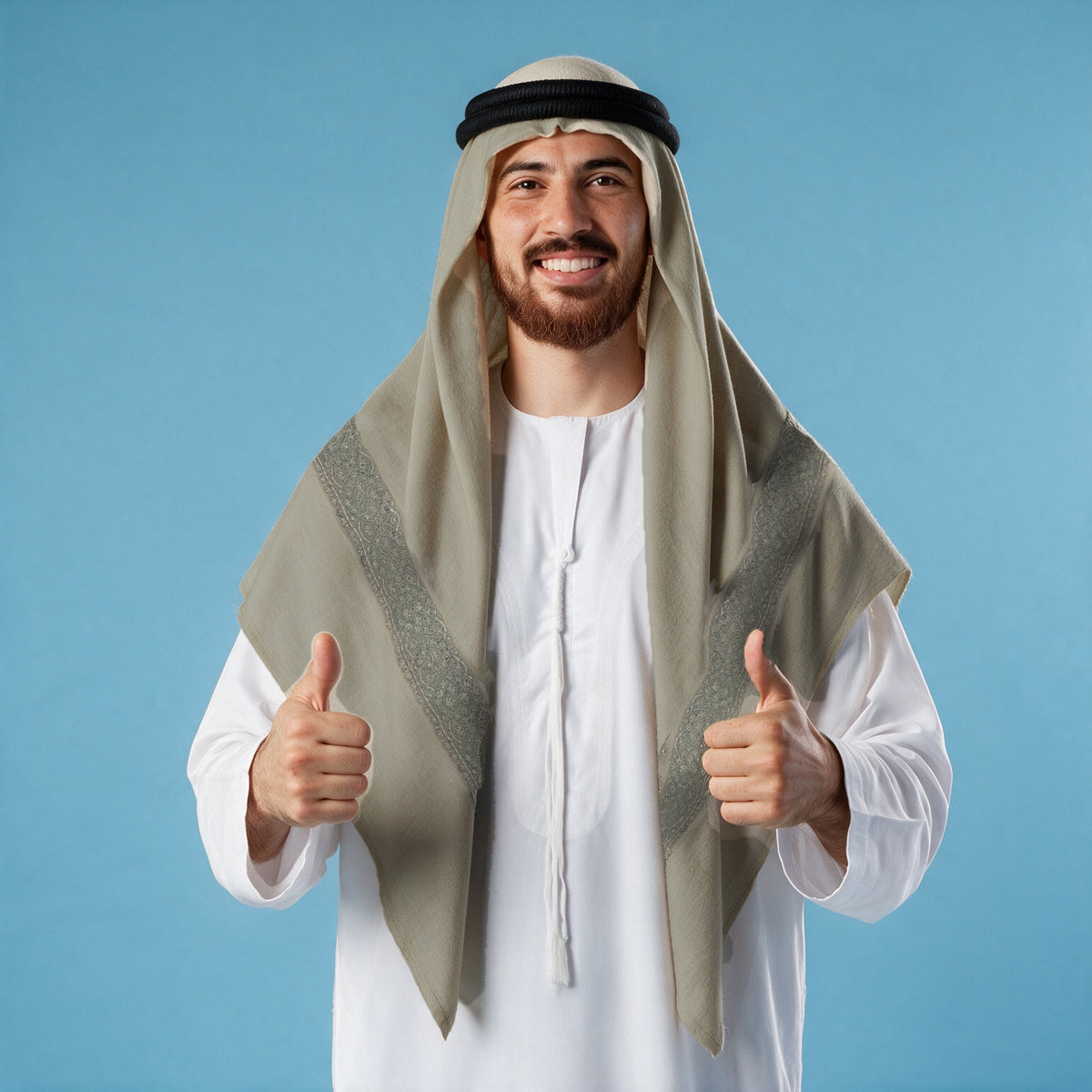 Man wearing the Nuqrah Kashmiri pashmina ghutra with a black agal and white thobe, silver grey sozni border on each front end