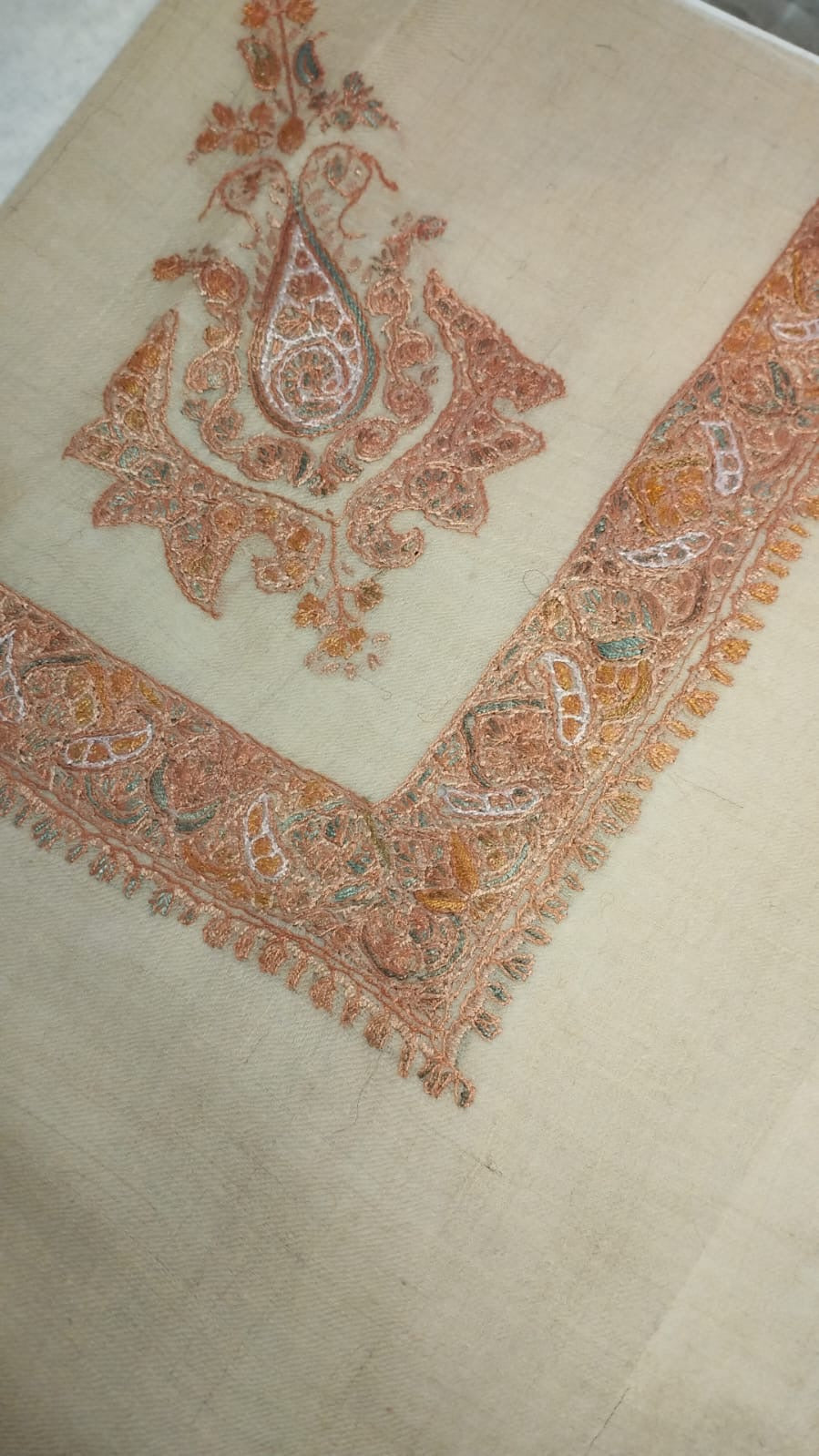 Nafud Kashmiri pashmina ghutra, oatmeal base with a soft apricot and terracotta corner motif and paisley border