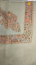 Qantara Kashmiri pashmina ghutra, oatmeal base with a peach and black corner motif and an arched border, touched with sky blue and coral