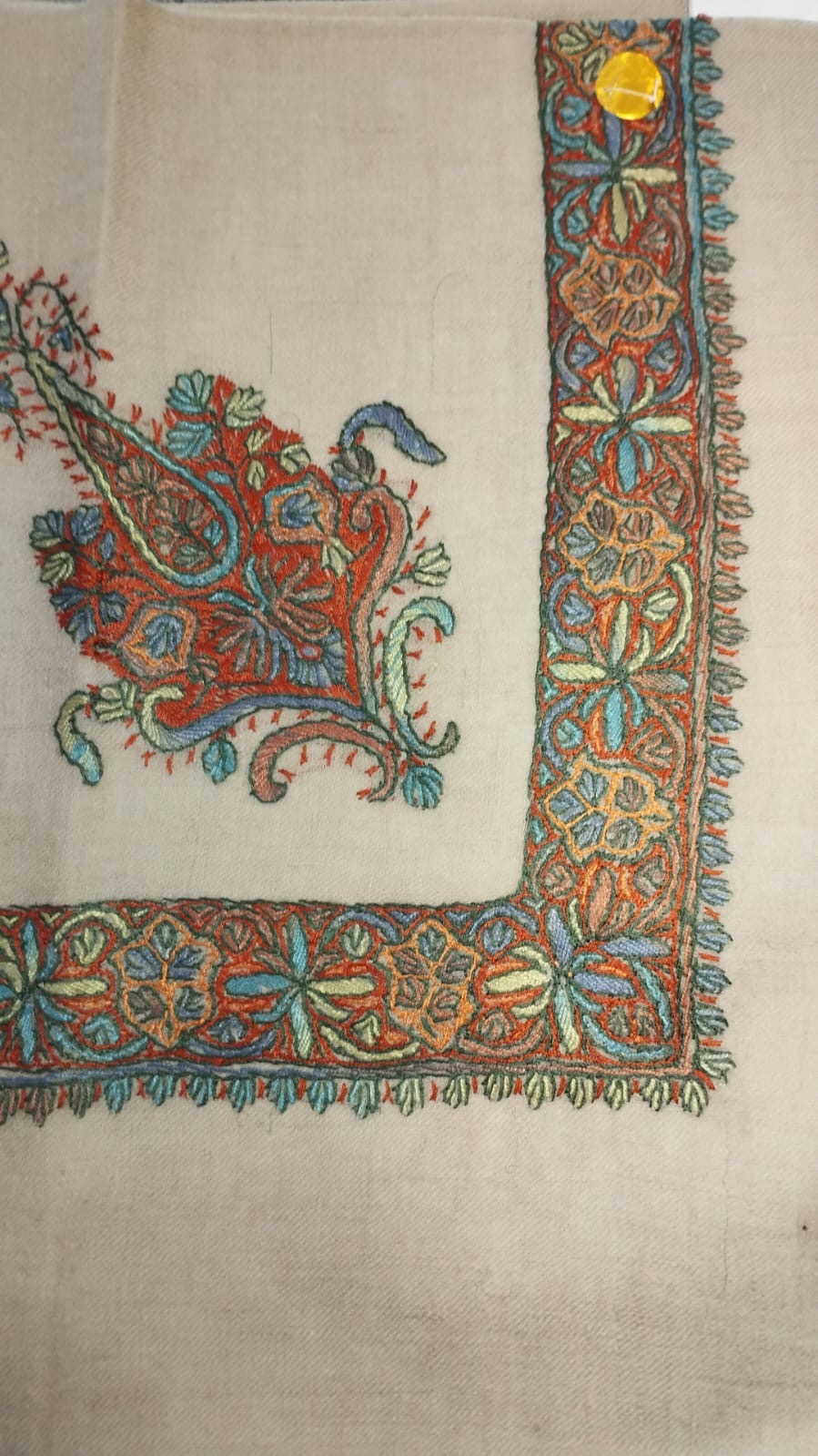 Qaws Kashmiri pashmina ghutra, oatmeal base with a brick red, sky blue and lime green corner motif and a rust border of blue and green leaf stars