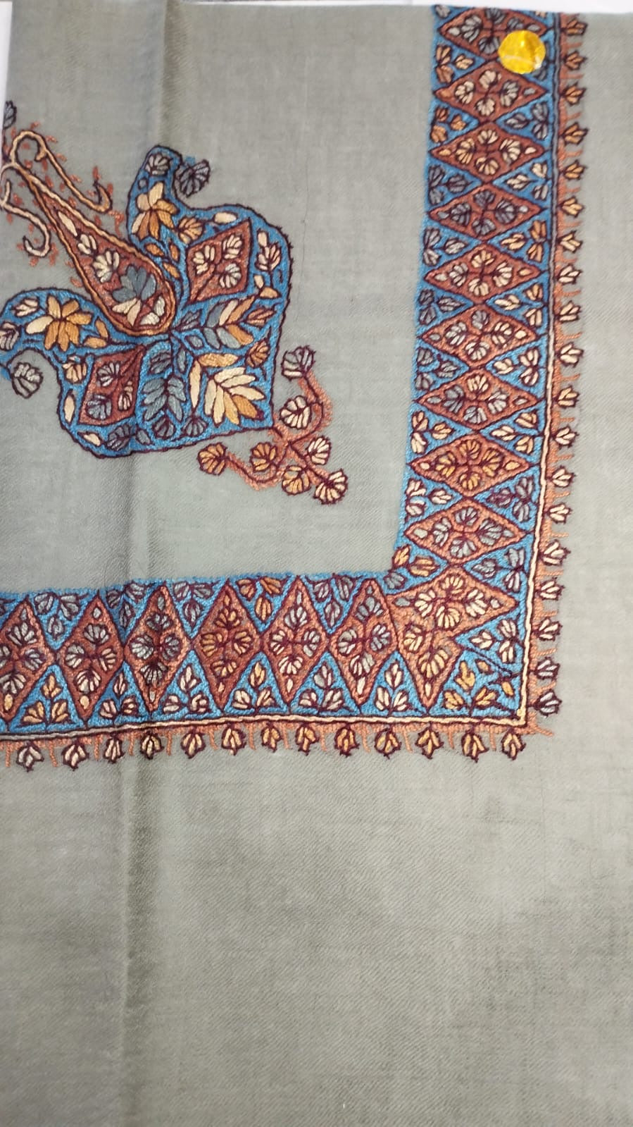 Azraq Kashmiri pashmina ghutra, stone grey base with a cerulean blue and rust corner motif and lozenge border