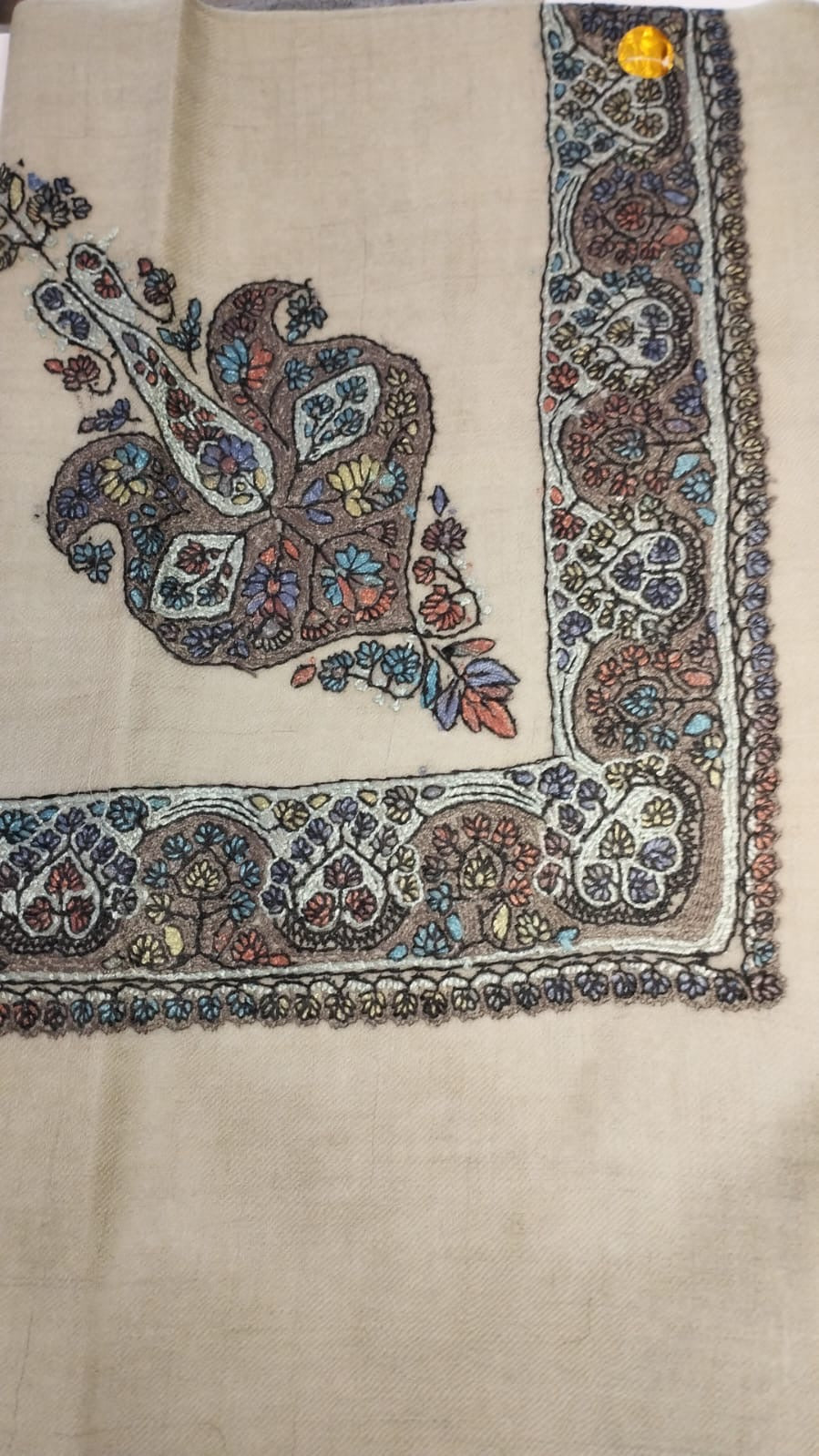 Abanus Kashmiri pashmina ghutra, oatmeal base with a dark brown and ivory corner motif and border, scattered with pastel blue, rose and saffron flowers