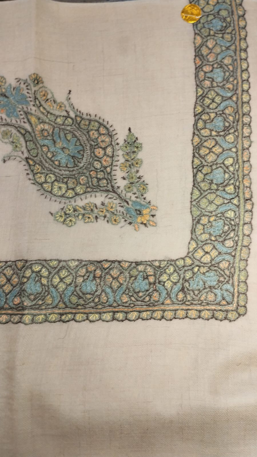 Waha Kashmiri pashmina ghutra, oatmeal base with an aqua blue and olive green corner motif and border, outlined in black