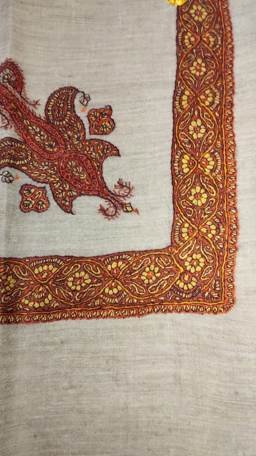 Dahna Kashmiri pashmina ghutra, oatmeal base with a rust red corner motif and a burnt orange border of saffron flowers