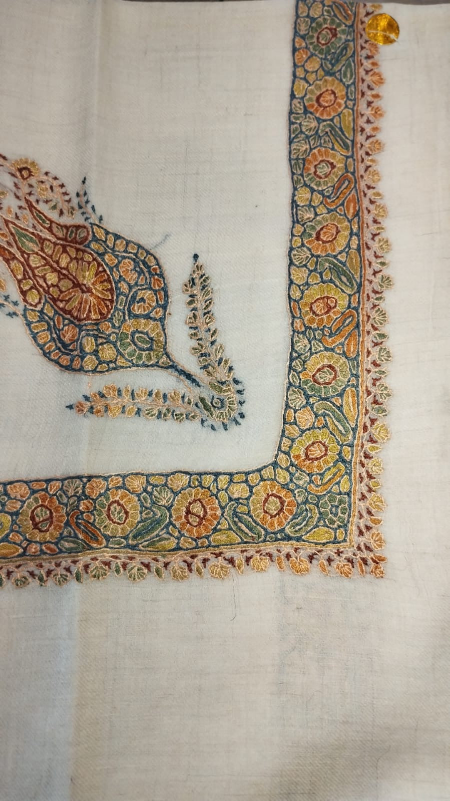 Sundus Kashmiri pashmina ghutra, oatmeal base with a teal and amber corner motif and a teal border of amber rosettes