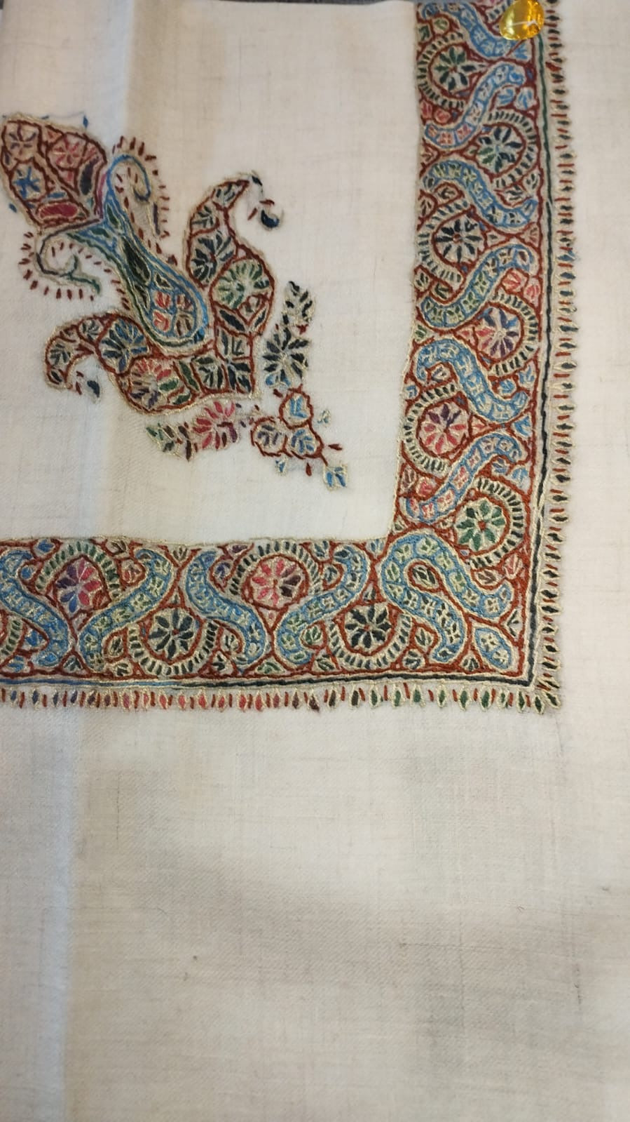 Karm Kashmiri pashmina ghutra, cream base with a rust red and sky blue corner motif and a scrolling vine border