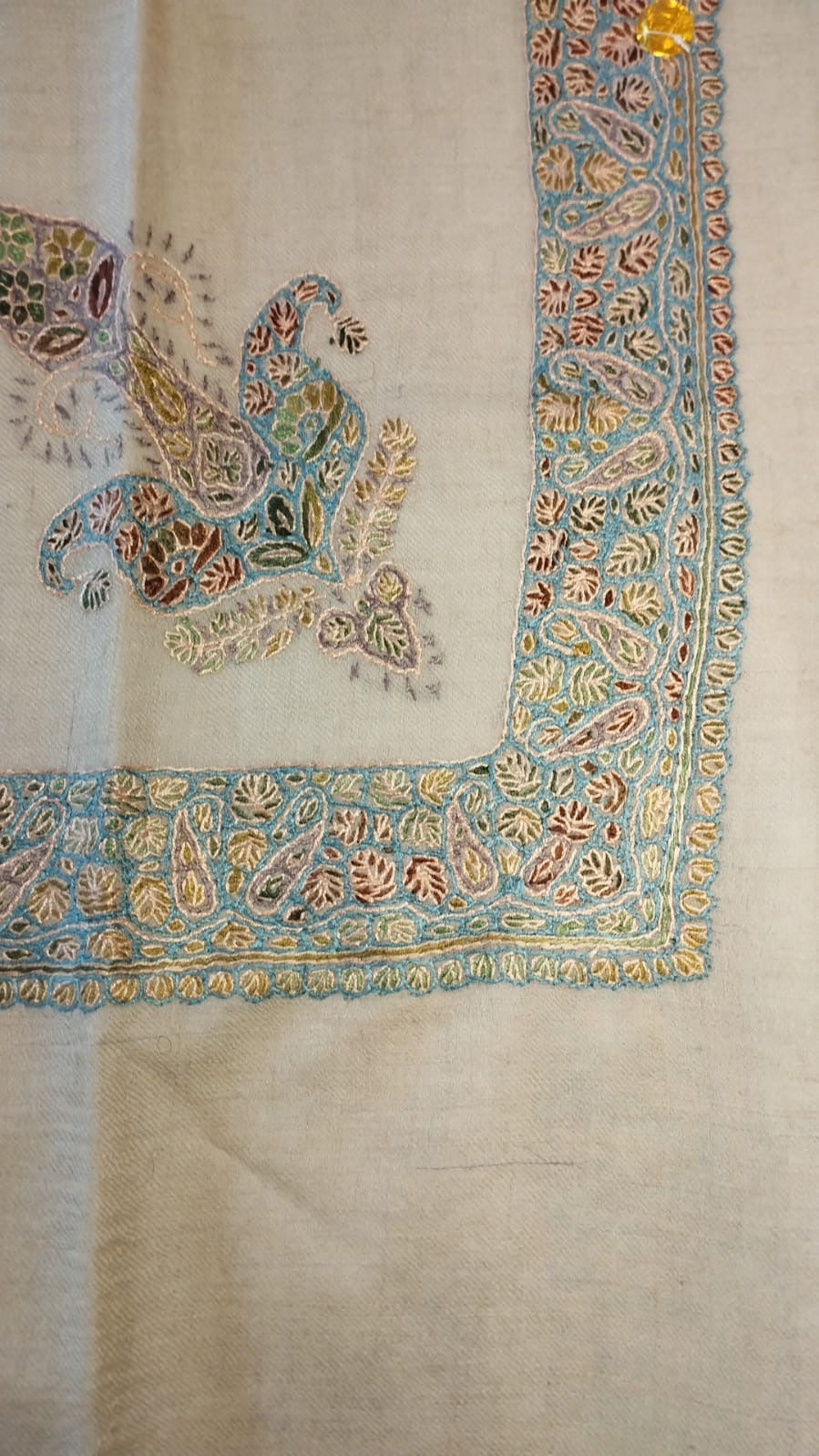 Ghaim Kashmiri pashmina ghutra, oatmeal base with a soft pastel corner motif and a pale aqua border of gold and rust leaves