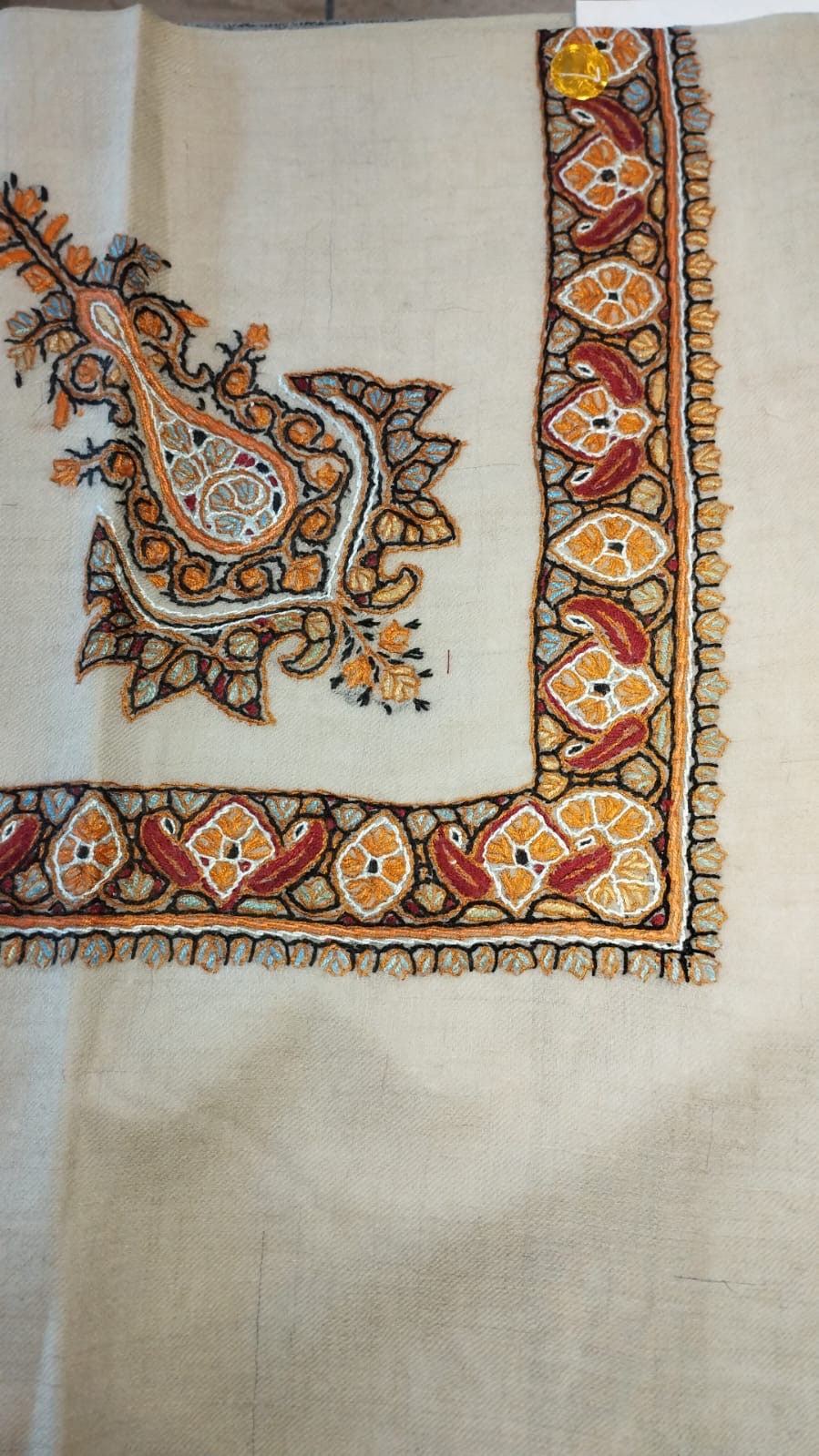 Nimr Kashmiri pashmina ghutra, oatmeal base with an amber orange and black corner motif and a border of amber flowers and crimson paisleys