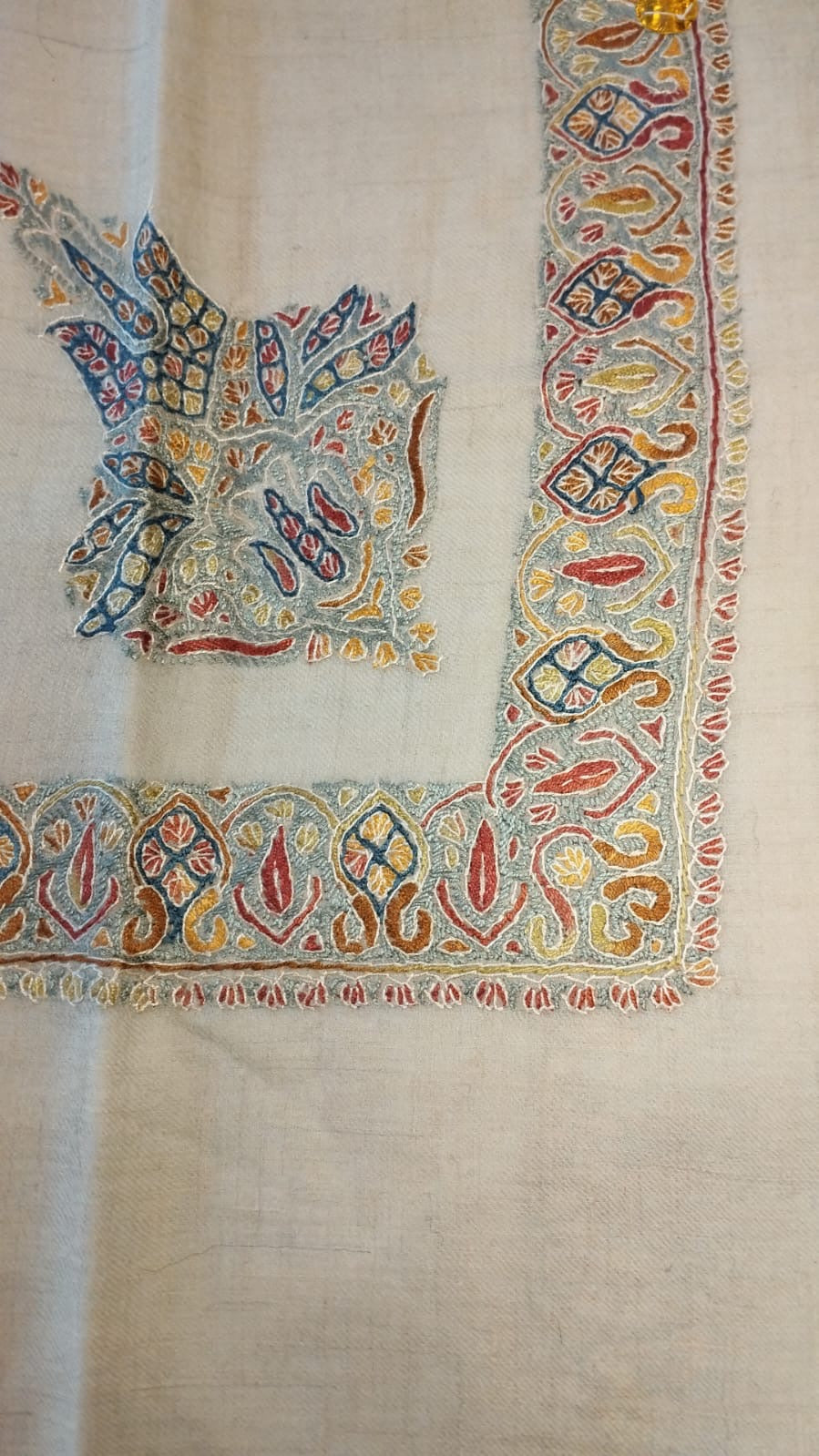 Nasim Kashmiri pashmina ghutra, oatmeal base with a pale blue corner motif and a pale blue border of crimson and mustard scrolls