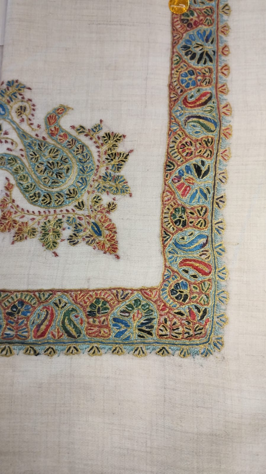 Fustuq Kashmiri pashmina ghutra, cream base with a sage green corner motif and a paisley border in rust and sky blue