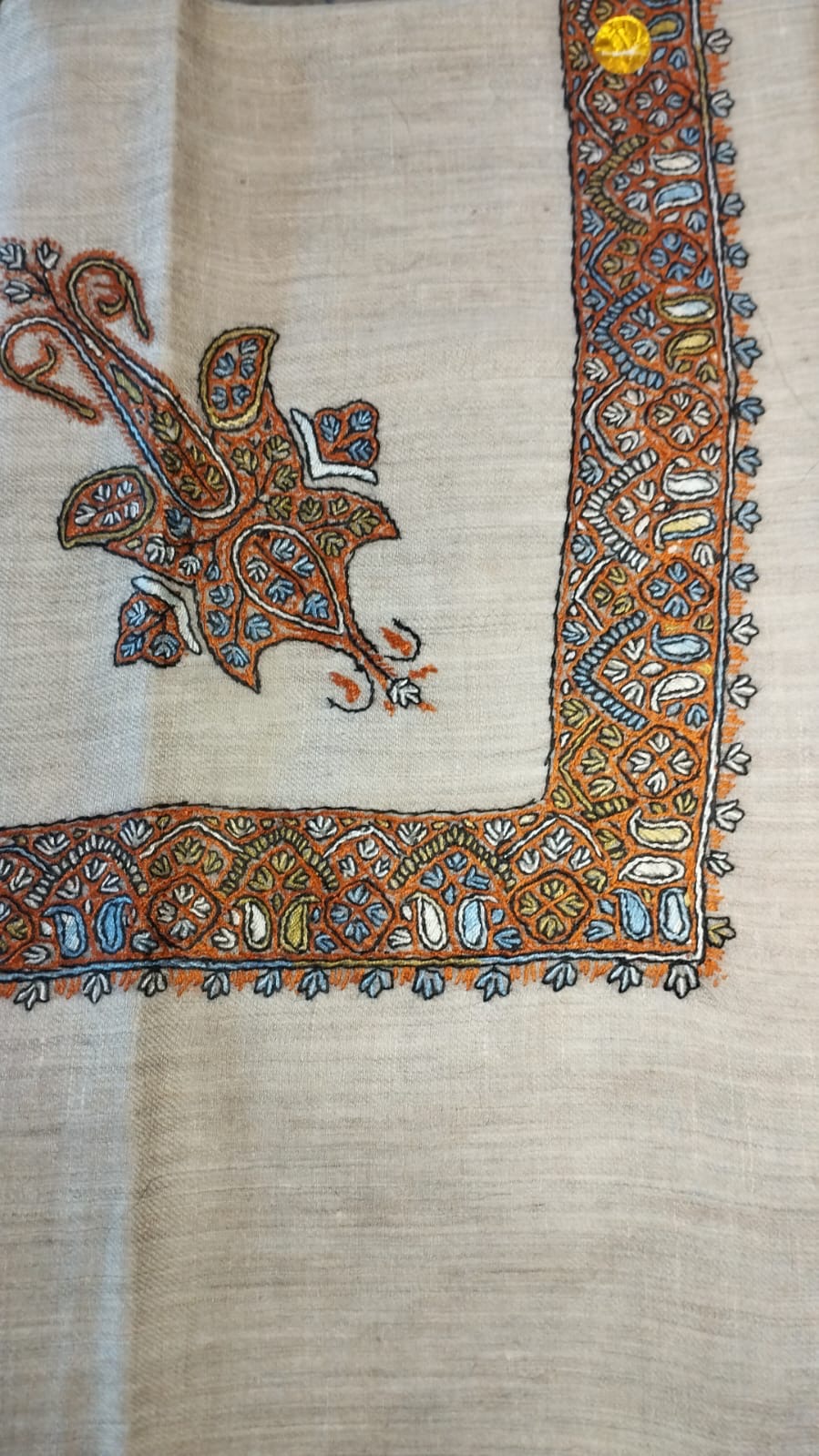 Burtuqal Kashmiri pashmina ghutra, oatmeal base with a burnt orange corner motif and border, with sky blue almonds and black outlines