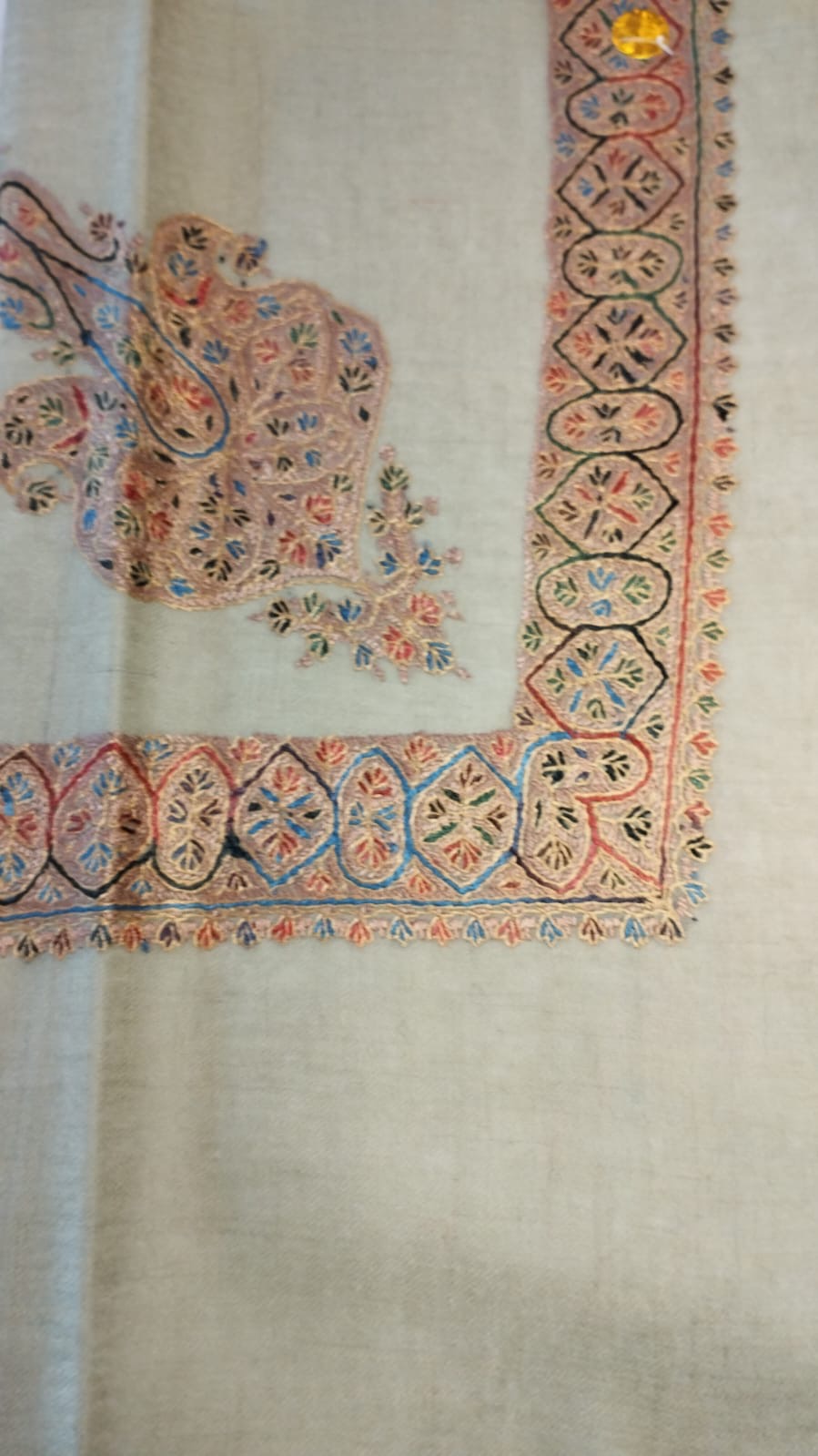 Riwaq Kashmiri pashmina ghutra, oatmeal base with a blush coral corner motif and arched border, with sky blue and black accents