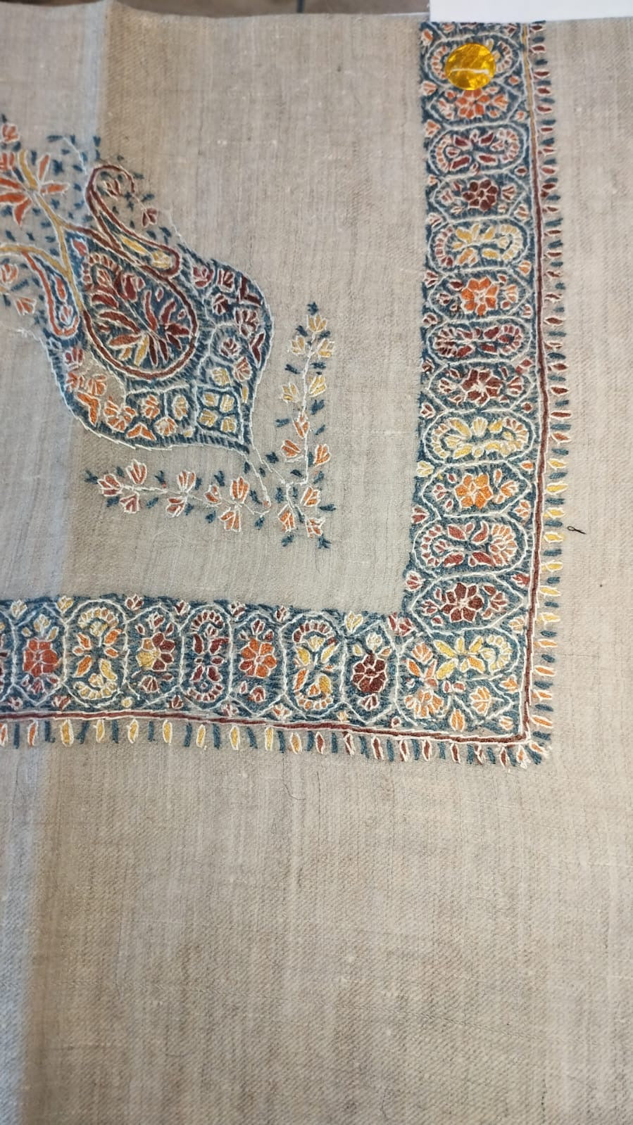 Bulbul Kashmiri pashmina ghutra, oatmeal base with a teal and rust corner motif and a teal border of saffron and rust rosettes