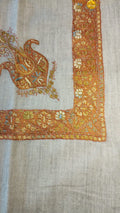 Suhail Kashmiri pashmina ghutra, oatmeal base with a burnt amber corner motif and border, with ivory and sky blue rosettes