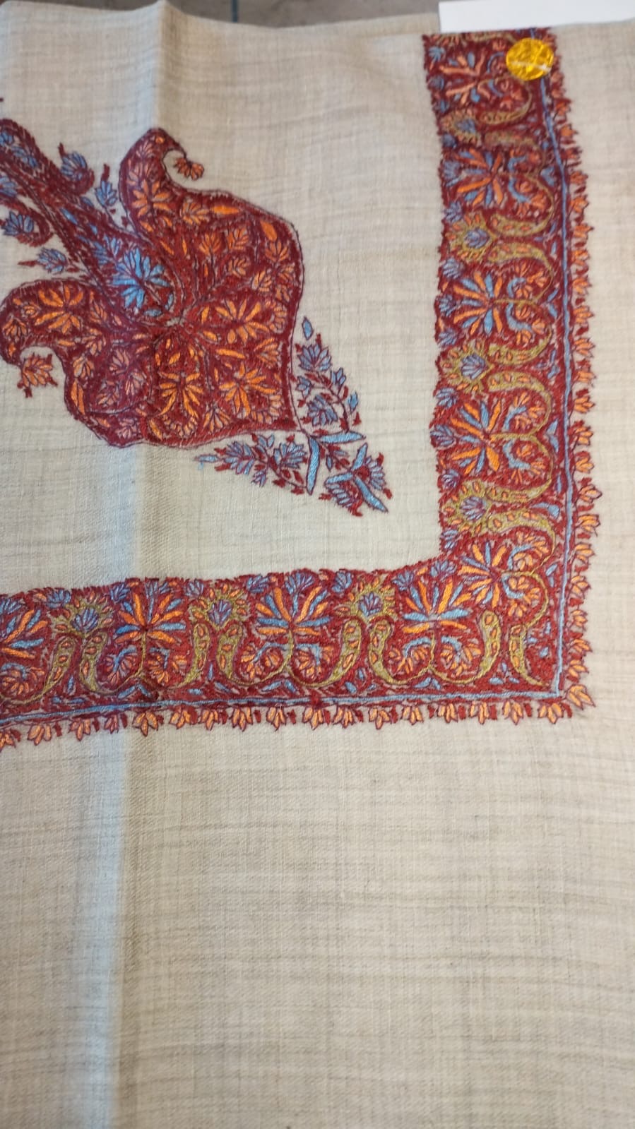 Hamra Kashmiri pashmina ghutra, oatmeal base with a crimson corner motif and border, with orange and periwinkle blue