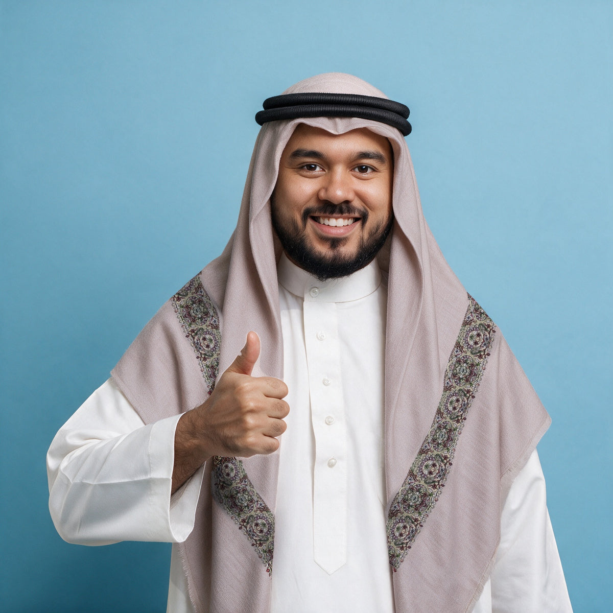 Man wearing the Sorme Qalam Kaari Super Turma Kashmiri semi pashmina in pale rose-grey with a black agal and white thobe, dense charcoal, olive, rose and pale gold multicolour pen-work border on each front end