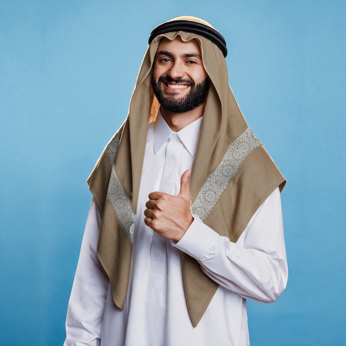 Man wearing the Mahtab Qalam Kaari Super Turma Kashmiri semi pashmina in warm camel beige with a black agal and white thobe, wide ivory white pen-work border on each front end