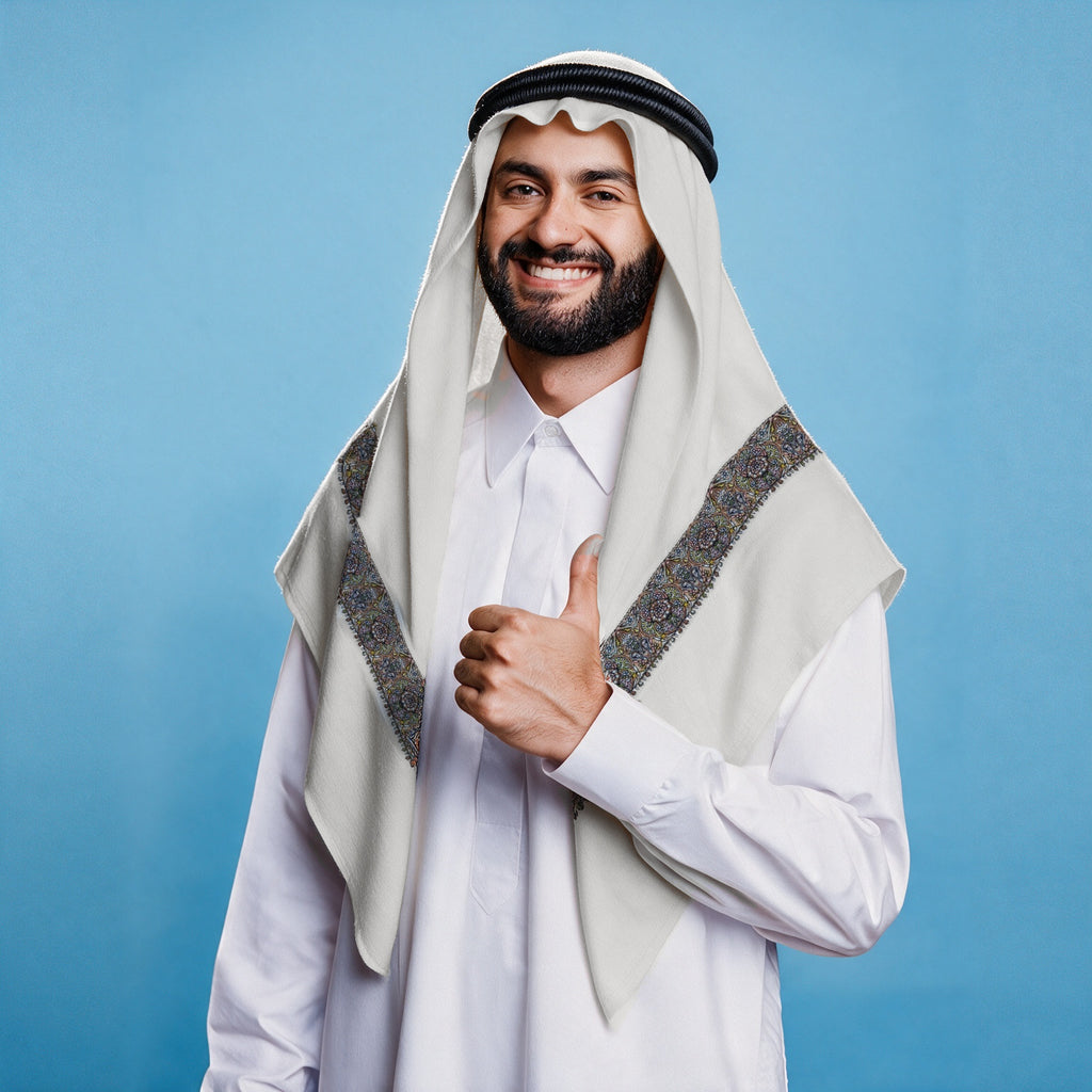 Man wearing the Layl Qalam Kaari Super Turma Kashmiri semi pashmina in soft natural white with a black agal and white thobe, dense indigo, brown, pastel pink and yellow multicolour pen-work border on each front end