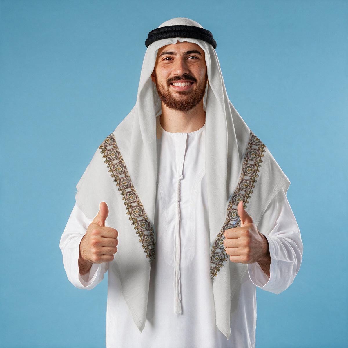 Man wearing the Bahar Qalam Kaari Super Turma Kashmiri semi pashmina in soft natural white with a black agal and white thobe, gold, sage green and dusky rose hexagonal medallion pen-work border on each front end