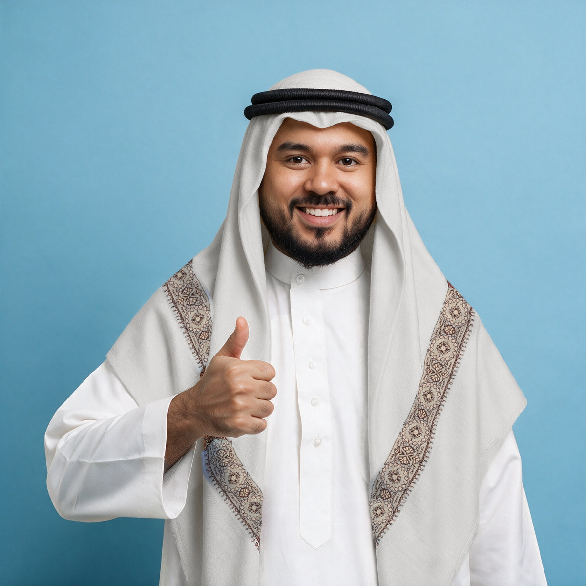 Man wearing the Zabeeb Qalam Kaari Super Turma Kashmiri semi pashmina in soft natural white with a black agal and white thobe, fine plum brown and peach pen-work border on each front end