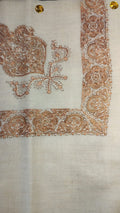 Surur Qalam Kaari Pashmina laid flat, copper and ivory paisley corner motif and rosette border on a natural oatmeal ground