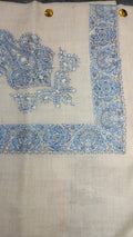 Darya Qalam Kaari Pashmina laid flat, sky blue and ivory paisley corner motif and rosette border on a natural oatmeal ground
