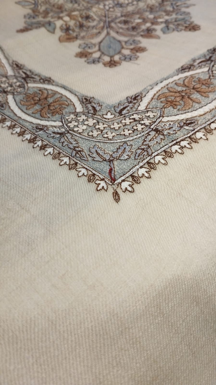 Close view of the Qirtas Qalam Kaari Pashmina corner, taupe, pale blue-grey and ivory hand-drawn sozni