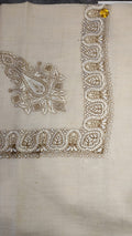 Lubban Qalam Kaari Pashmina laid flat, ivory and khaki paisley corner motif and winding paisley border on a natural oatmeal ground