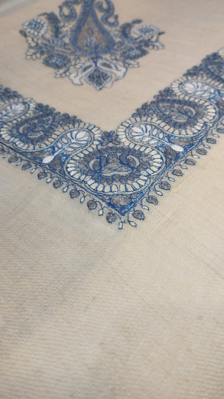 Close view of the Mihbara Qalam Kaari Pashmina corner, faded indigo and ivory hand-drawn sozni