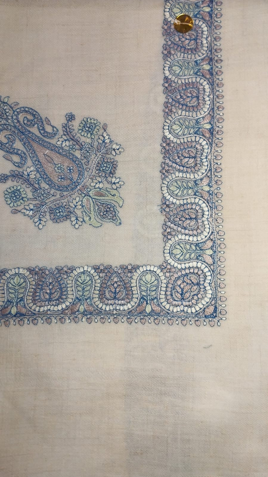 Andalib Qalam Kaari Pashmina laid flat, slate blue, dusty rose and sage paisley corner motif and winding paisley border on a natural oatmeal ground