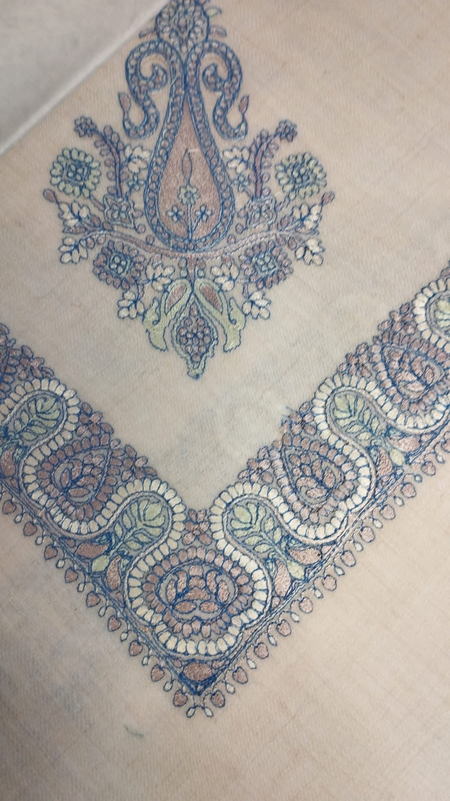 Andalib Qalam Kaari Pashmina folded to a point at the corner, showing the slate blue, dusty rose and sage paisley motif and winding paisley border