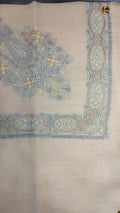 Sepehr Qalam Kaari Pashmina laid flat, pale sky blue, lilac and apricot floral bouquet corner motif and interlaced ribbon border on a natural oatmeal ground