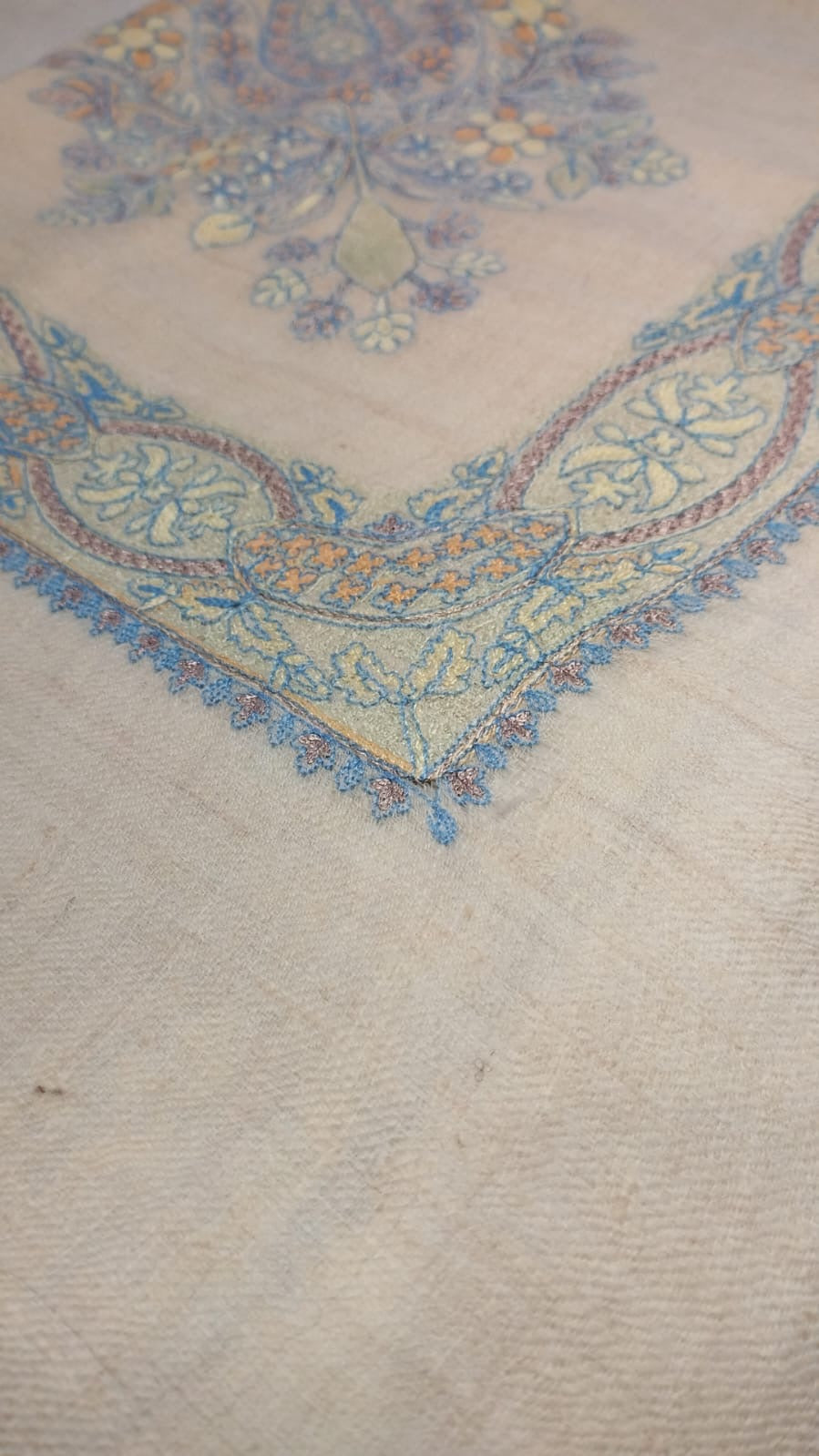 Close view of the Sepehr Qalam Kaari Pashmina corner, pale sky blue, lilac and apricot hand-drawn sozni