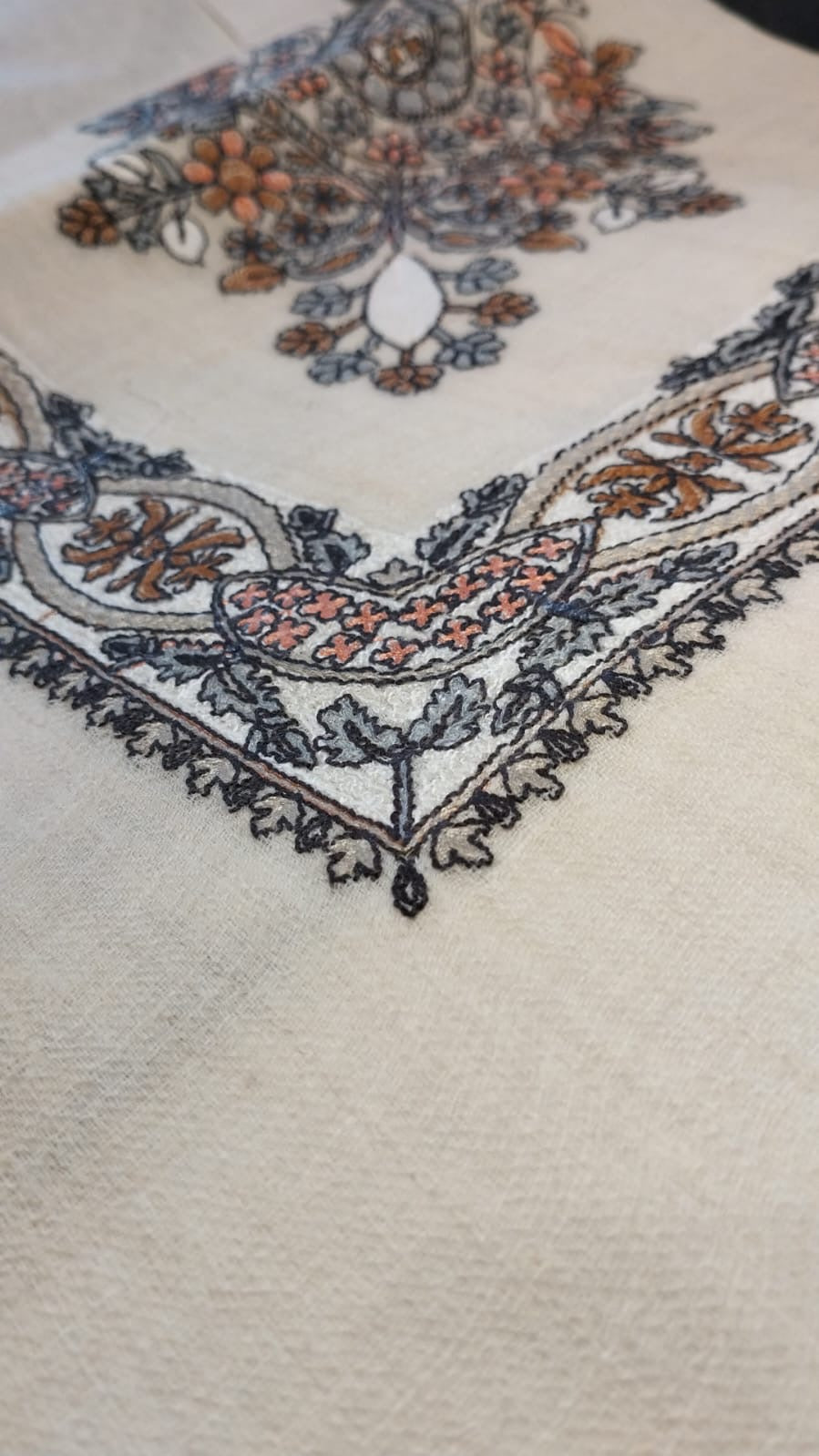 Close view of the Mijmar Qalam Kaari Pashmina corner, burnt orange, slate and charcoal hand-drawn sozni