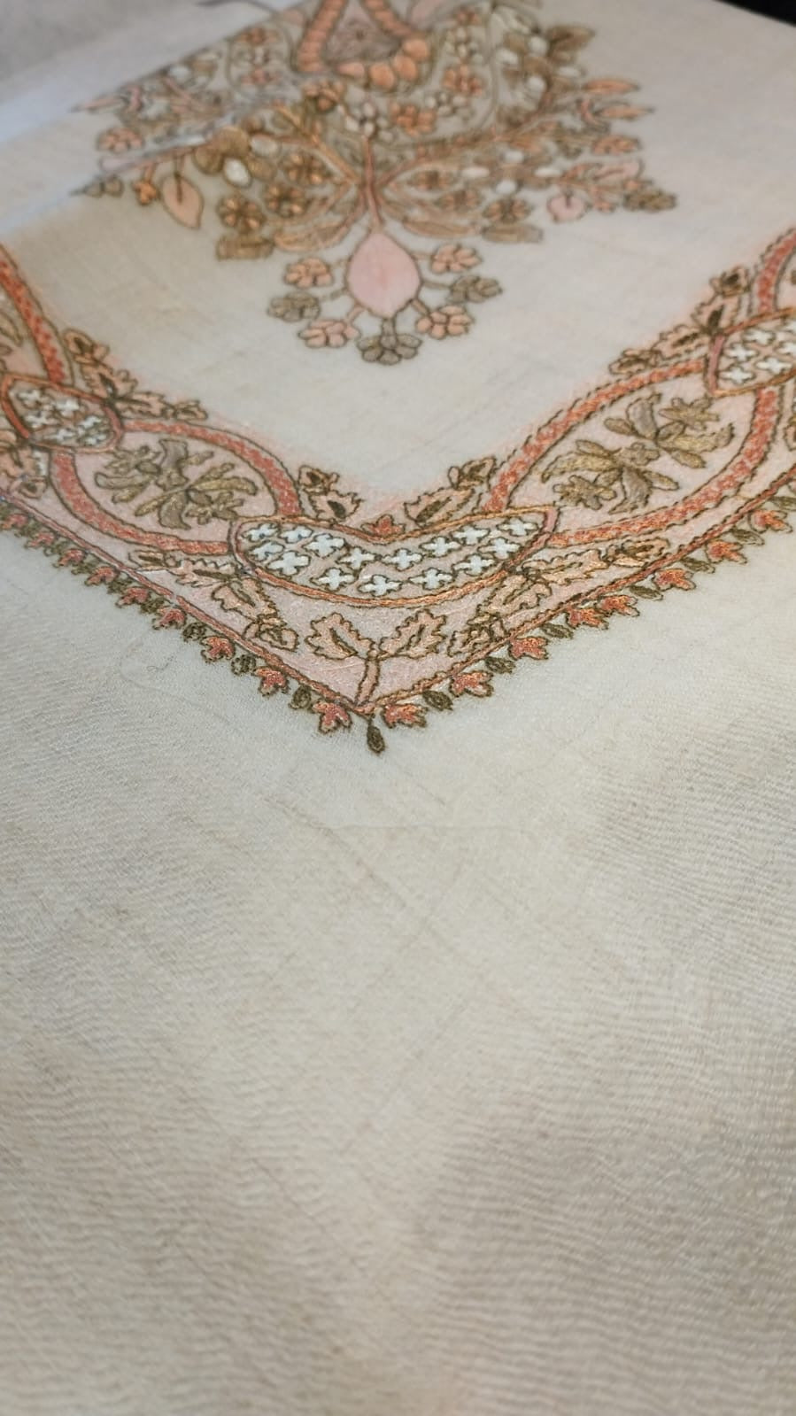Close view of the Rubai Qalam Kaari Pashmina corner, apricot and olive hand-drawn sozni