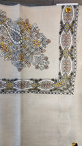Simurgh Qalam Kaari Pashmina laid flat, saffron yellow, grey-blue and rose floral bouquet corner motif and interlaced ribbon border on a natural oatmeal ground
