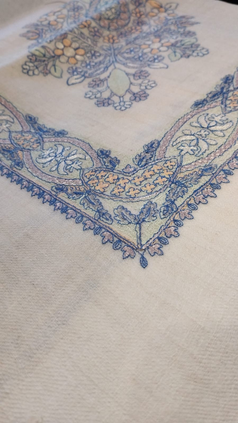 Close view of the Marsa Qalam Kaari Pashmina corner, sky blue and apricot hand-drawn sozni