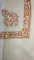 Qandil Qalam Kaari Pashmina laid flat, marigold and rust paisley corner motif and winding paisley border on a natural oatmeal ground