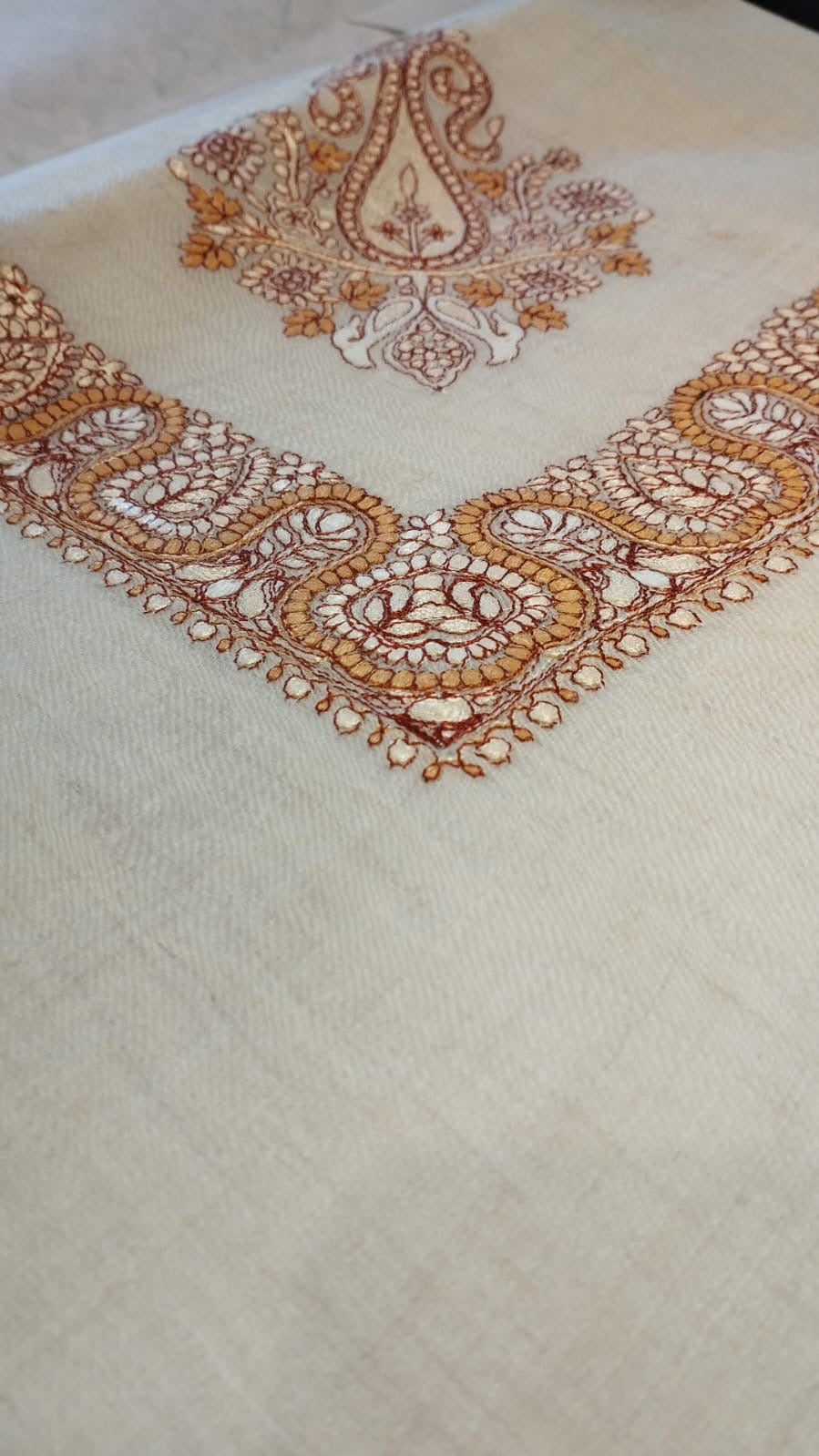 Close view of the Qandil Qalam Kaari Pashmina corner, marigold and rust hand-drawn sozni