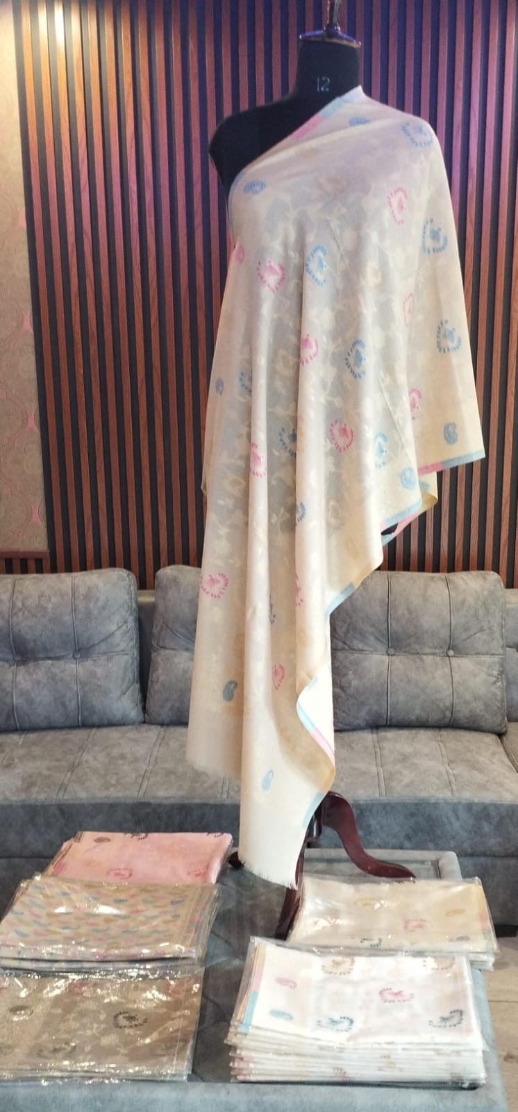 Najma Kashmiri semi pashmina stole draped on a mannequin, cream with pastel sprays