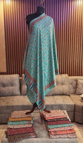 Nilufar Kashmiri semi pashmina shawl draped on a mannequin, turquoise florals